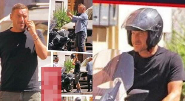 Francesco Totti, le foto sotto casa di Noemi Bocchi: lei esce prima, lui si nasconde sotto al casco