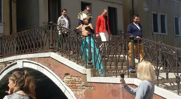 Set fotografico bollente: modella a seno scoperto in posa sui ponti veneziani
