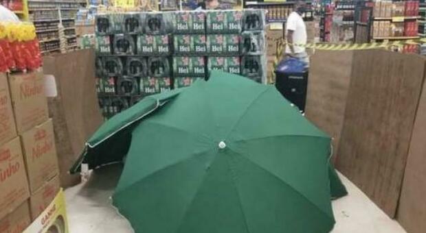 Il dipendente muore di infarto, il corpo viene coperto da ombrelloni per lasciare il supermercato aperto